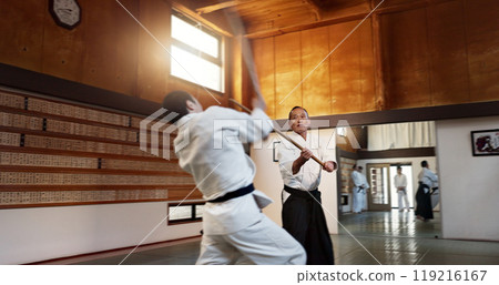 Aikido men, fight and bokken for martial arts, weapon or contest for black belt students at training, gym or dojo. Japanese people, wood sword and sensei for exercise, workout and fitness in battle Aikido men, fight and bokken for martial arts, weapon or contest for black belt students at training, gym or dojo. Japanese people, wood sword and sensei for exercise, workout and fitness in battle 119216167