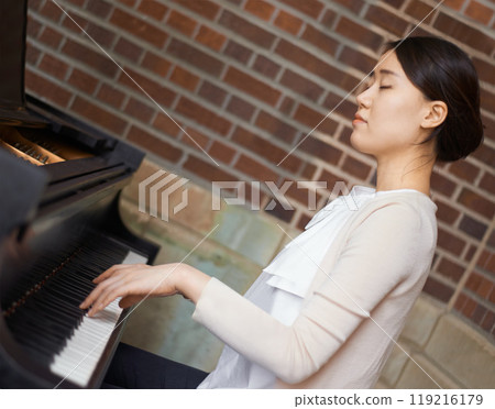 Piano, musician or calm woman in home for music training for an artistic classical performance for peace. Creative lady, relax or Asian person playing a song for learning practice routine in Japan Piano, musician or calm woman in home for music training for an artistic classical performance for peace. Creative lady, relax or Asian person playing a song for learning practice routine in Japan 119216179