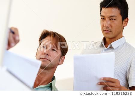 Documents, laptop or business people in meeting for report, agenda discussion or portfolio in project. Diversity, teamwork or workers planning in office talking, conversation or speaking of paperwork 119216228