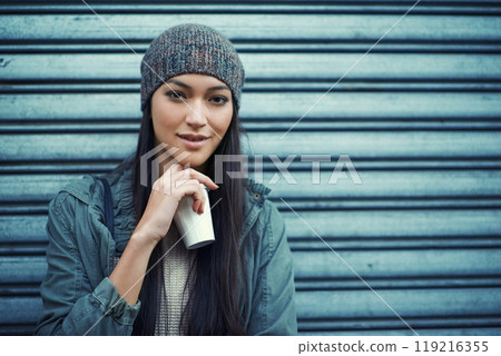 Woman, fashion and coffee with portrait, urban and city street or background for style. Asian student, beanie and jacket in cape town with winter, cold and planning with metal garage door with denim 119216355