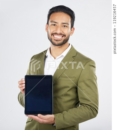Happy asian man, portrait and tablet on mockup in advertising against a white studio background. Businessman with technology display or screen in marketing, advertisement or branding on mock up space Happy asian man, portrait and tablet on mockup in advertising against a white studio background. Businessman with technology display or screen in marketing, advertisement or branding on mock up space 119216457