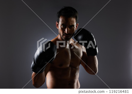 Boxing, studio portrait and sports man with fitness challenge motivation, gym club commitment and fight power workout. Dark shadow, boxer training exercise and strong MMA athlete on grey background 119216481