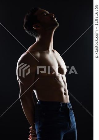Bodybuilder man, shirtless and studio profile with wellness, healthy body and black background. Young guy, fitness and silhouette in dark, thinking and strong with ideas, health and topless for art 119216559