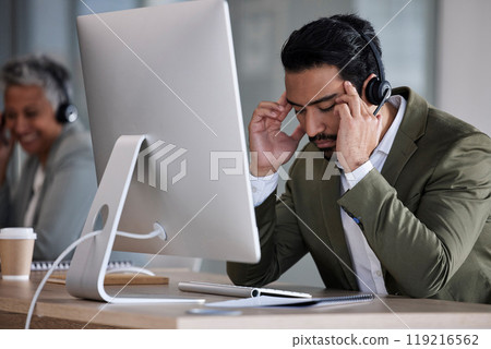 Telemarketing, headache and man with stress, call center and burnout in office, overworked and fatigue. Male employee, consultant and agent for customer service, tech support and anxiety in workplace 119216562