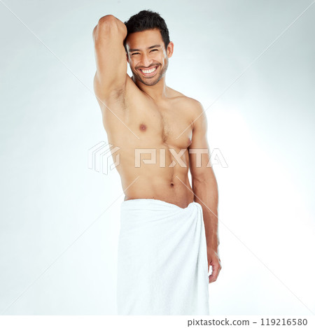 Portrait, body and happy asian man with a towel in studio for shower, wellness or cosmetics on white background. Bathroom, face and Japanese male model smile for luxury pamper, grooming or treatment 119216580