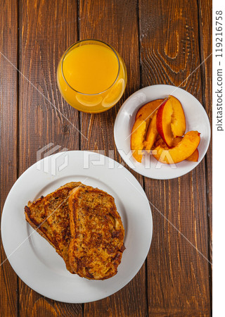French toast on a plate with blueberries, orange juice, nectarine for breakfast French toast on a plate with blueberries, orange juice, nectarine for breakfast 119216758