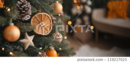 Christmas tree with dried orange slices and wooden stars. Natural eco decor. Wide banner, copy space 119217025