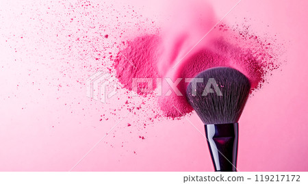 Pink powder spreading into the air from a makeup brush Pink powder spreading into the air from a makeup brush 119217172