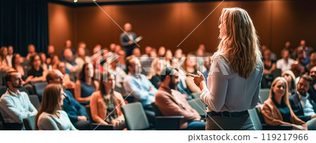 Presenter speaking to a focused audience 119217966