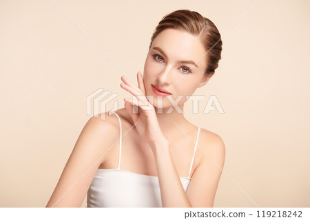 Beautiful young woman with clean fresh skin on beige background, Face care, Facial treatment, Cosmetology, beauty and spa, women portrait. Beautiful young woman with clean fresh skin on beige background, Face care, Facial treatment, Cosmetology, beauty and spa, women portrait. 119218242