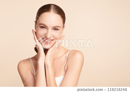 Beautiful young woman with clean fresh skin on beige background, Face care, Facial treatment, Cosmetology, beauty and spa, women portrait. Beautiful young woman with clean fresh skin on beige background, Face care, Facial treatment, Cosmetology, beauty and spa, women portrait. 119218248