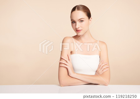 Beautiful young woman with clean fresh skin on beige background, Face care, Facial treatment, Cosmetology, beauty and spa, women portrait. Beautiful young woman with clean fresh skin on beige background, Face care, Facial treatment, Cosmetology, beauty and spa, women portrait. 119218250