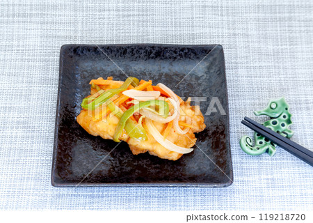White fish served on a plate with a thickened sauce 119218720