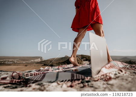 Woman in Red Dress Walking Away from a Laptop 119218723