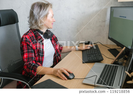 Mature Woman Working from Home Office on Desktop and Laptop Mature Woman Working from Home Office on Desktop and Laptop 119218856