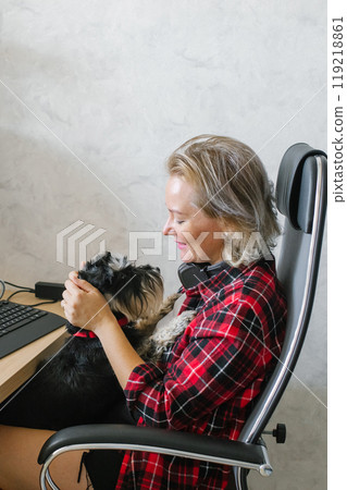 Businesswoman Relaxing with Her Dog at Home Office 119218861