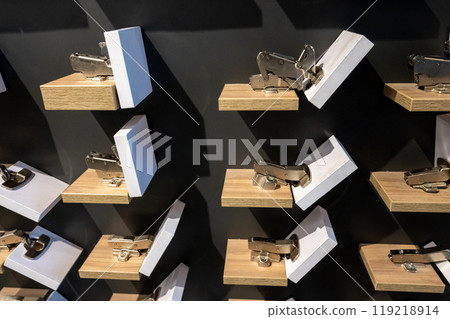 Display of Modern Kitchen Cabinet Hinges on Shelves 119218914
