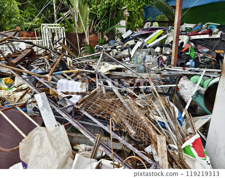 A pile of garbage with a bucket, rope, bottles, and other items at a landfill A pile of garbage with a bucket, rope, bottles, and other items at a landfill 119219313