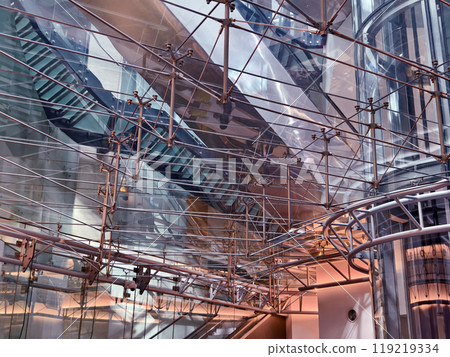 A modern tall building that features a significant amount of glass 119219334