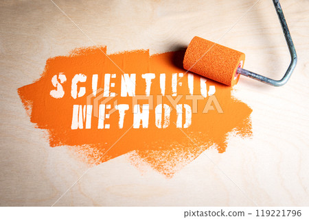Scientific Method. Orange paint and paint roller on wood texture background Scientific Method. Orange paint and paint roller on wood texture background 119221796