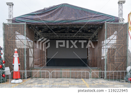 Empty outdoor stage with festive decorations set up for an upcoming event 119222945