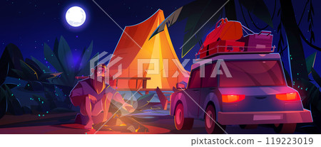Man sitting near campfire, tent and car at night 119223019