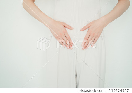 Woman rubbing her stomach with her hand Woman rubbing her stomach with her hand 119224937