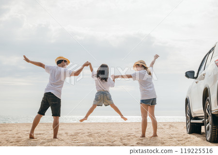 Happy family three hand in hand and jumping on sandy beach, Parents father and mother jump their children back car, holiday vacations summer road trip, Family day enjoying their time together Happy family three hand in hand and jumping on sandy beach, Parents father and mother jump their children back car, holiday vacations summer road trip, Family day enjoying their time together 119225516