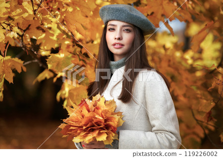Portrait of a beautiful woman in an autumn park Portrait of a beautiful woman in an autumn park 119226002