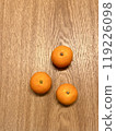 Three tangerines on a table 119226098