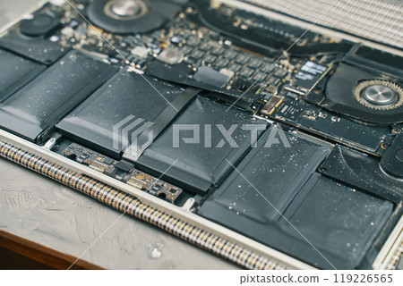 A detailed closeup view showcasing laptop battery components along with dustcovered circuitry elements 119226565