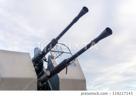 Double-barreled naval automatic cannon against the sky close-up Double-barreled naval automatic cannon against the sky close-up 119227143