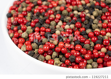 A mixture of different peppercorns on a white background 119227211