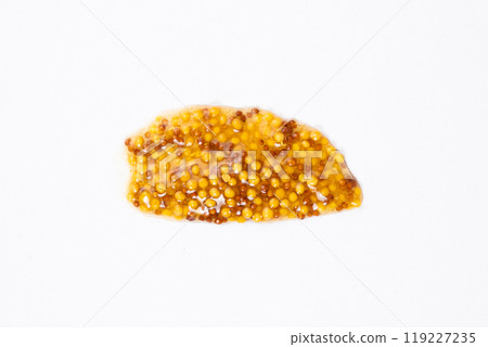 Smear of French Dijon mustard on a white background, top view Smear of French Dijon mustard on a white background, top view 119227235