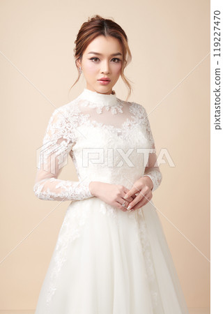 Beautiful young asian woman in wedding dress on beige background, 119227470