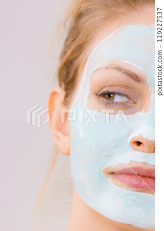 Girl with white green mud mask on face 119227537