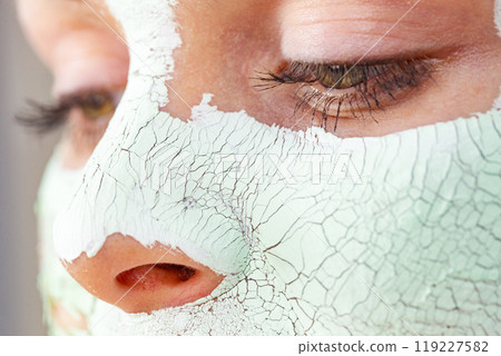 Girl with mud mask on face 119227582