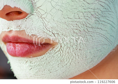 Girl with mud mask on face 119227606