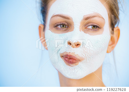 Girl with dry white mud mask on face Girl with dry white mud mask on face 119227628