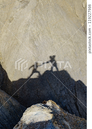 Shadow of two people on rock mountain Shadow of two people on rock mountain 119227986