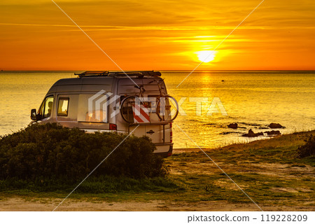 Camper with bicycles on rack camping on beach at sunrise Camper with bicycles on rack camping on beach at sunrise 119228209