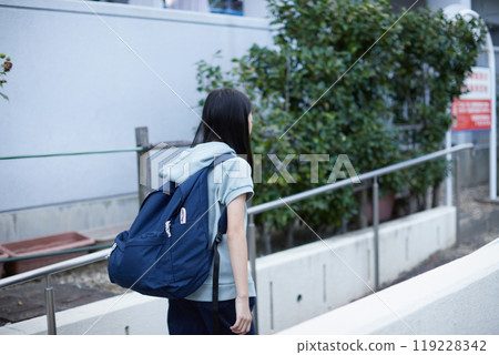 Children walking happily on the grounds of a housing complex on an autumn afternoon on their way to school 119228342