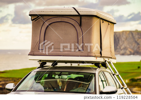 Car with roof top tent camp on sea shore 119228504