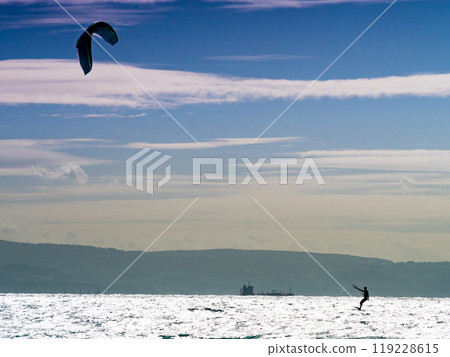 Kite surfer riding waves. Kiteboarding sport. Kite surfer riding waves. Kiteboarding sport. 119228615