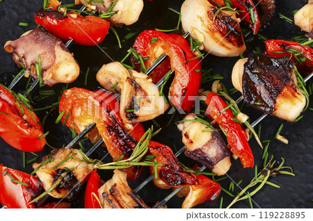 Grilled octopus on skewers. 119228895