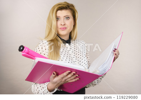 Happy positive business woman holding binder with documents Happy positive business woman holding binder with documents 119229080