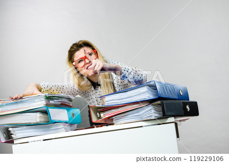 Energized business woman in office Energized business woman in office 119229106