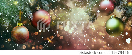 Christmas ornaments hanging from a fir tree branch with falling snow and a blurred background 119229456