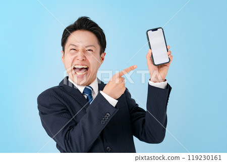 Businessman laughing with a smartphone 119230161