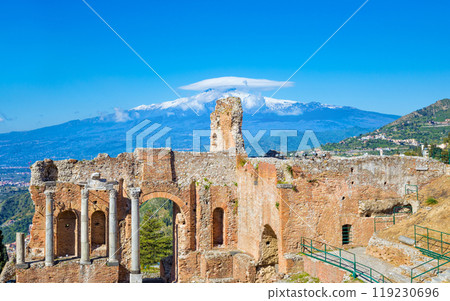 Ancient Greek theatre in Taormina on background of Etna Volcano, Italy 119230696